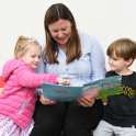 Pupils and teacher reading together at Eaton House the Manor Nursery