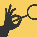A hand holding a magnifying glass