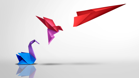 An origami swan taking flight and turning into a paper aeroplane