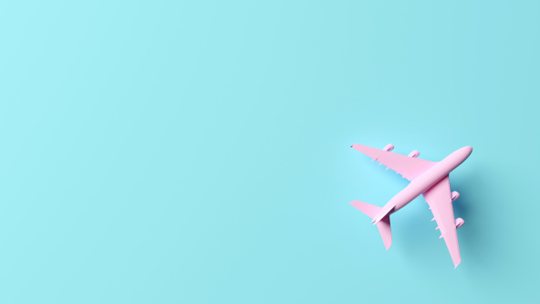 A pink aeroplane on a blue background