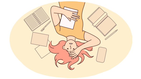 Girl student lying on the floor clutching head after experiencing burnout associated with overload
