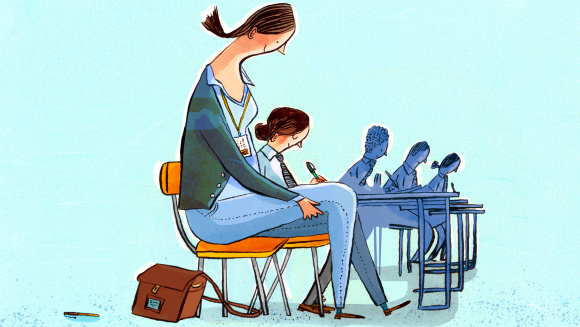 A teaching assistant helping a child in the classroom