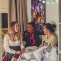 Boarding pupils at New Hall School sit on a dormitory bed